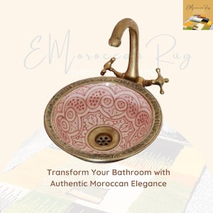 May include: A brass sink with a pink and white patterned ceramic basin. The sink has a brass faucet with a single handle.