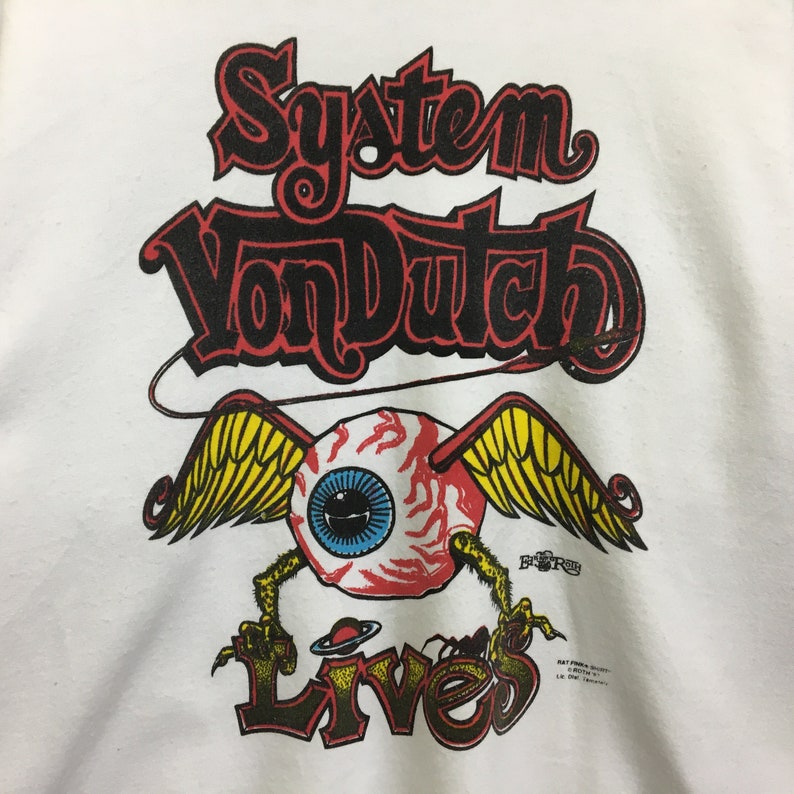 May include: White t-shirt with a black and red graphic print of a winged eyeball with the text "System Von Dutch Lives".