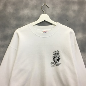 May include: White sweatshirt with a black and white graphic of a cartoon rat with the text "Rat Fink" and "Ed "Big Daddy" Roth" on the front.