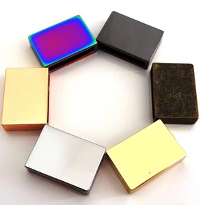 May include: Six different colored metal slider buckles. The buckles are rectangular and have a smooth finish. The colors are gold, silver, black, brass, rainbow, and yellow.