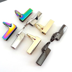 May include: Assortment of six metal bag hardware clasps in various finishes, including rainbow, silver, gold, and black.