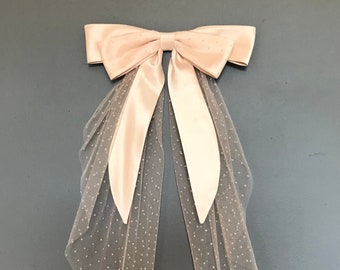 Blush wedding hair bow with spotty veiling