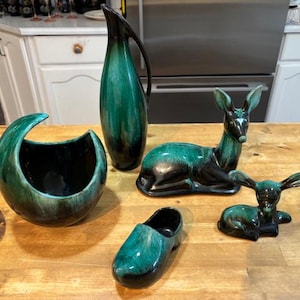 May include: A set of three ceramic vases in varying heights and shapes. The vases are glazed in a matte white finish, offering a minimalist aesthetic. The tallest vase is approximately 25 cm high.