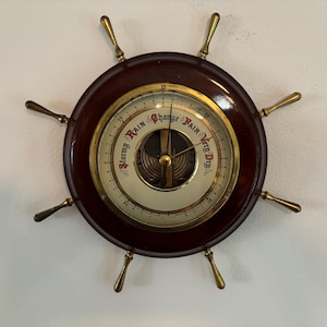 Ship's Wheel Barometer Germany; Lord Nelson's Victory Brass Bell; St. Malo Souvenirs - Life Saver with Mirror & WC Wall Plaque with Sailboat