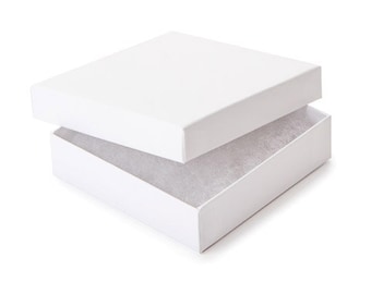 May include: A white cardboard box with a lid, the lid is open and the box is lined with white tissue paper.