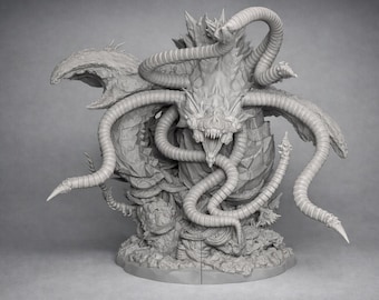 May include: A detailed, gray sculpture of a monstrous creature with multiple tentacles, sharp teeth, and a textured body. The sculpture has a detailed base and is likely a fantasy or horror-themed collectible.
