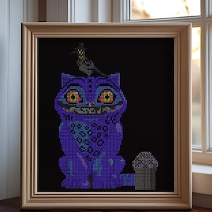 May include: Cross-stitch art of a purple cat with yellow eyes and a black bird wearing a top hat. The cat has a mischievous grin and is set against a black background. The artwork is framed in a light brown wooden frame.