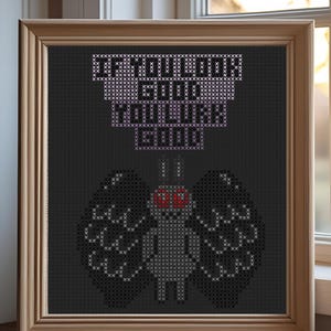 Puede incluir: Obra de arte de punto de cruz en un marco de madera. El diseño presenta una polilla con alas grandes y detalladas y ojos rojos, debajo del texto "IF YOU LOOK GOOD YOU LOOK GOOD" en púrpura. El fondo es negro.