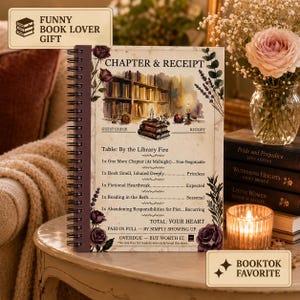 May include: A spiral-bound notebook titled CHAPTER & RECEIPT featuring a watercolor illustration of a library, books, and candles. The text lists items like One More Chapter, Book Smell, and Fictional Heartbreak with prices like Priceless and Expected.
