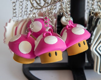 Sube de nivel tus llaves: Llavero, collar y accesorios para mochila con forma de hongo de Super Mario Bros.