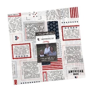 May include: A square fabric panel with a patriotic theme, featuring red, white, and blue designs. The fabric includes text, postage stamp-like frames, and an American flag motif. A label reads "INDEPENDENCE DAY".