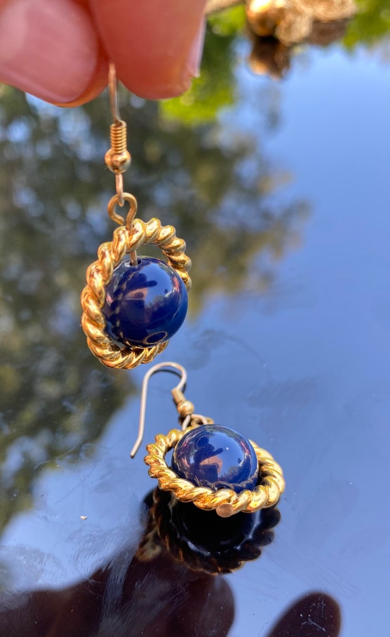 Blue ball and gold tone metal dangle earrings