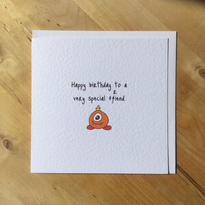 May include: A set of three ceramic mugs with a speckled, matte finish. The mugs are in shades of cream, light gray, and dark gray. Each mug has a simple, minimalist design and a rounded handle.