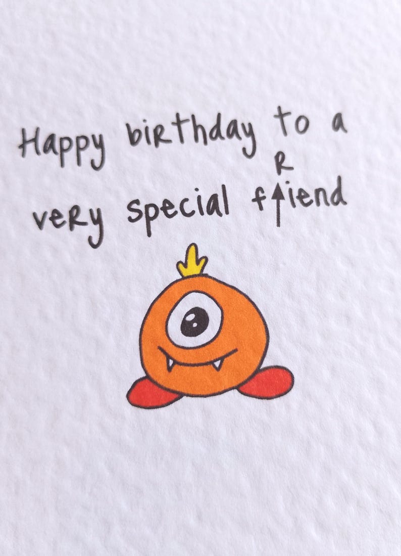 May include: A birthday card with the handwritten message "Happy birthday to a very special friend." The card features a cartoon orange monster with one eye, a yellow crown, and red feet.