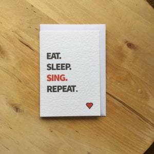 Carte pour chanter, carte pour chanter, chanteurs, Eat. Dormez. Chantez, répétez.