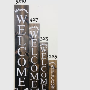 4 different sizes of welcome sign for front door. 5 feet tall, 4 feet tall, 3 feet tall and 2 feet tall. Roman font, with wreath accent at top and bottom.