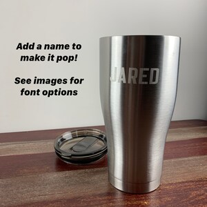 May include: A stainless steel tumbler with a lid. The tumbler has the name "JARED" engraved on the side.