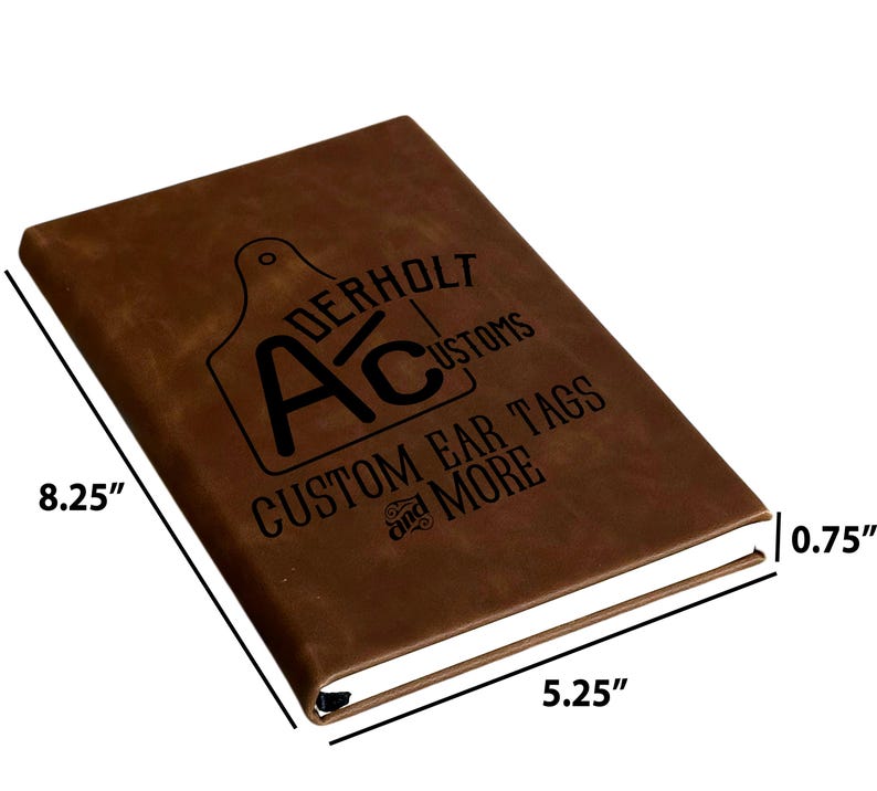 May include: A brown notebook with a black logo featuring the text Aderholt Customs and Custom Ear Tags and More. The notebook measures 8.25 inches in length, 5.25 inches in width, and 0.75 inches in thickness as indicated by the labels.
