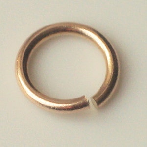 May include: A gold-toned jump ring, a small metal ring used for connecting jewelry components.