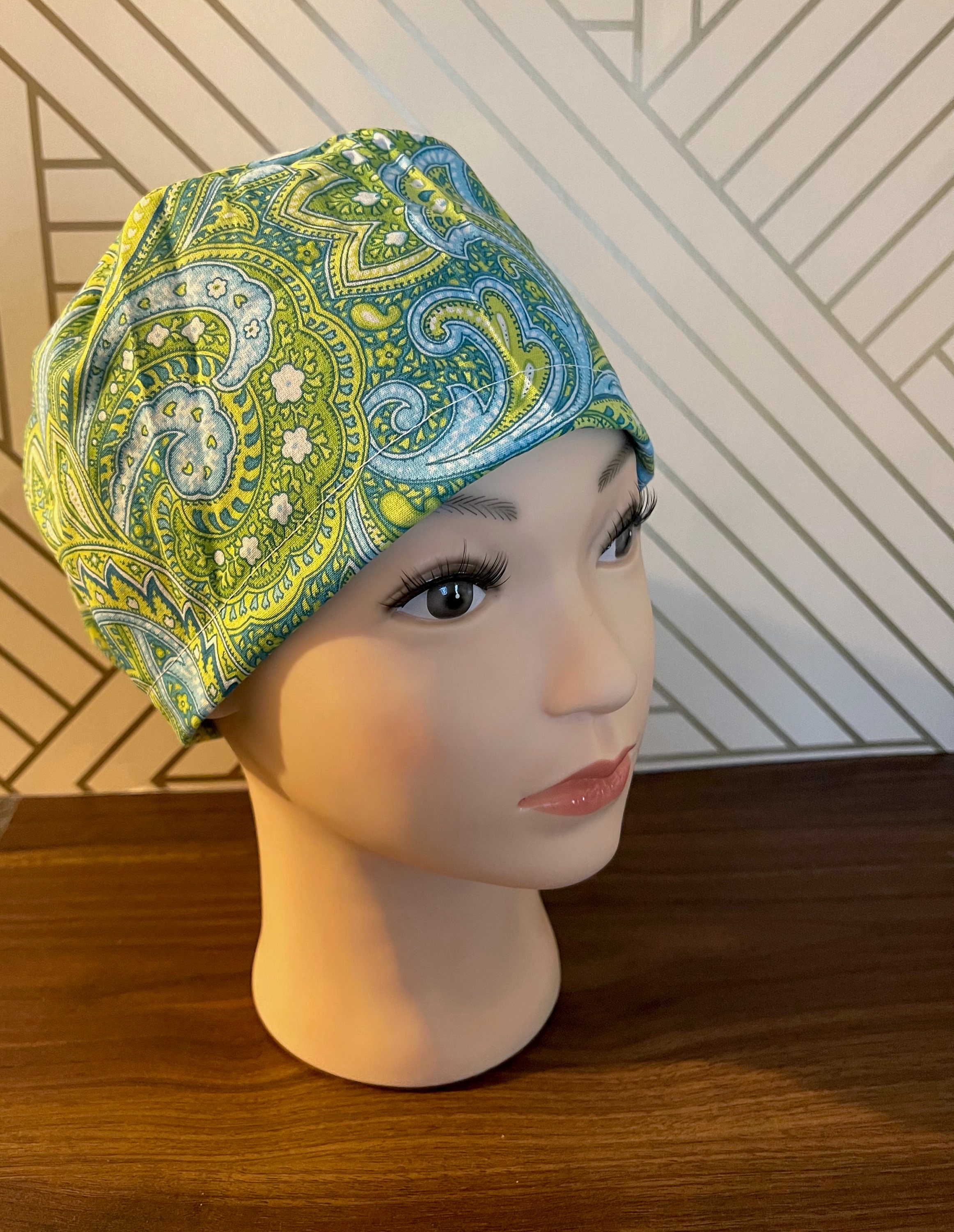 Paisley with green and blue scrub cap. With choice of European or ponytail. Add ons available: buttons or satin lining