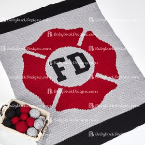 May include: A crocheted blanket with a red and gray fire department symbol in the center. The symbol has the letters "FD" in black. The blanket is made with black, red, and gray yarn.