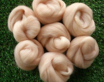 May include: Six balls of light peach colored wool roving. The wool is soft and fluffy, perfect for felting or spinning.