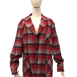 May include: A red, blue, and gray plaid flannel shirt with a button-up front and two patch pockets.