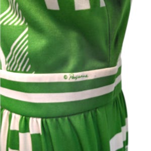 May include: A green and white patterned dress with a checkered and striped design. The dress features a white waistband with the brand name "Haggar" in green script. The fabric is a vibrant green with white accents.