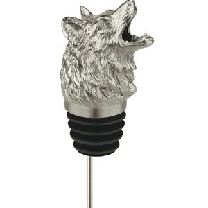 May include: A silver-toned metal bottle stopper featuring a detailed, three-dimensional wolf head howling with its mouth open. The stopper includes a black, ribbed rubber seal and a thin, straight metal stem extending from the bottom base.
