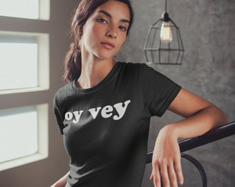 May include: A black t-shirt with the text "oy vey" printed in white on the front.