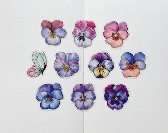 May include: A set of ten stickers featuring purple, pink, and blue pansies with gold accents. The stickers are perfect for adding a touch of whimsy to journals, planners, and other craft projects.