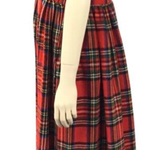 May include: A red, black, and green plaid sleeveless dress with a gathered skirt.