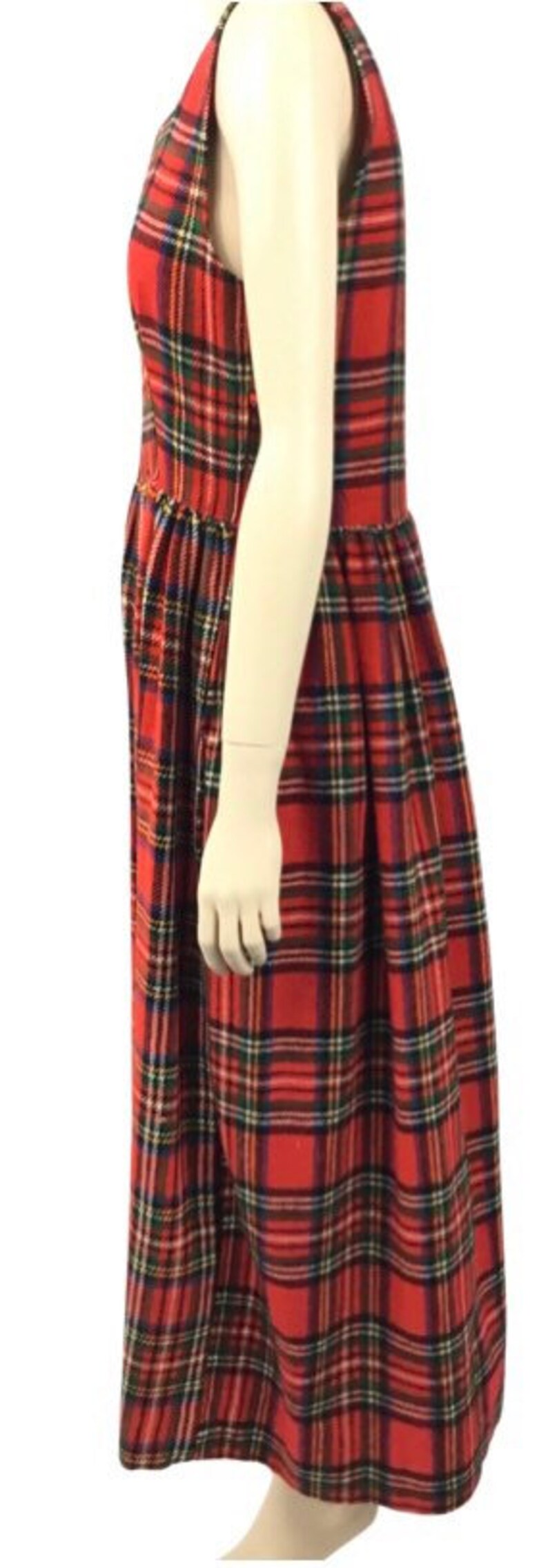 May include: A red, black, and green plaid sleeveless dress with a gathered skirt.