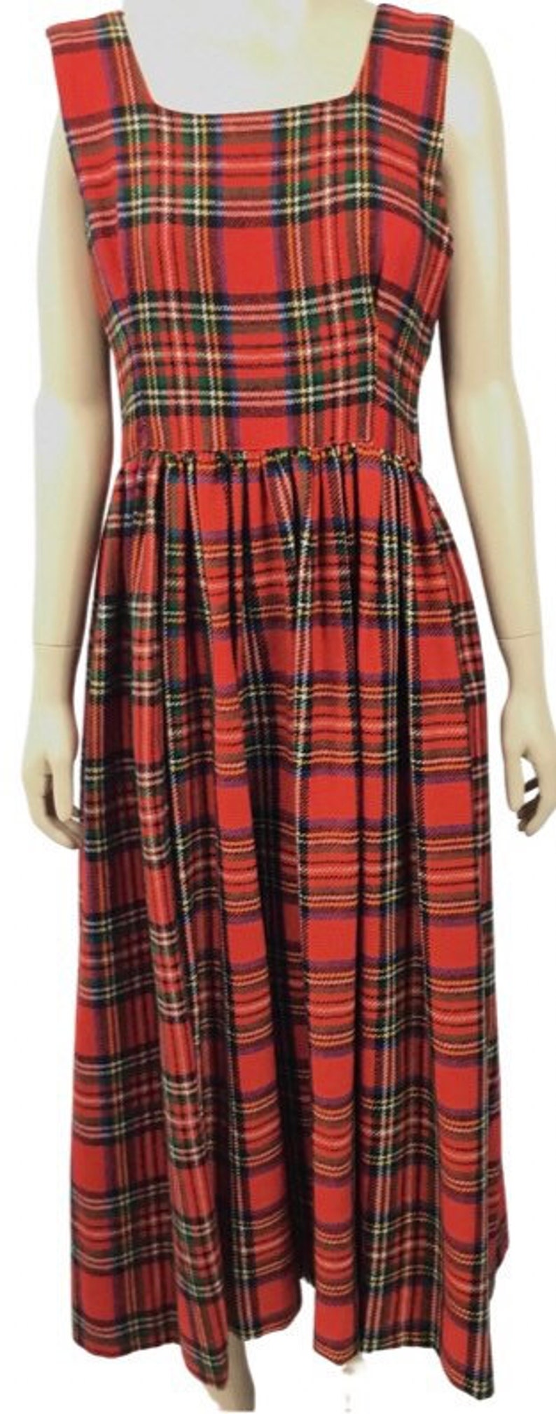 May include: A red, black, and white plaid sleeveless dress with a square neckline. The dress has a fitted bodice and a full skirt.