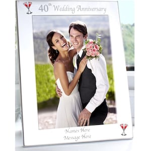 May include: A silver picture frame with the text "40th Wedding Anniversary" at the top. The frame holds a photo of a smiling couple. The bottom of the frame has the text "Names Here" and "Message Here".