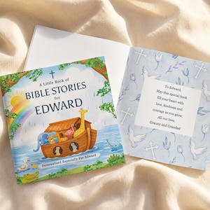 May include: A personalized children's book titled "A Little Book of Bible Stories for Edward." The cover features a colorful illustration of Noah's Ark with animals, a rainbow, and the sun. The inside page has a message.
