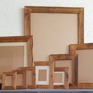 May include: A set of eight rustic wooden picture frames in various sizes. The frames are made of natural wood with a brown finish and have a simple, rectangular design.