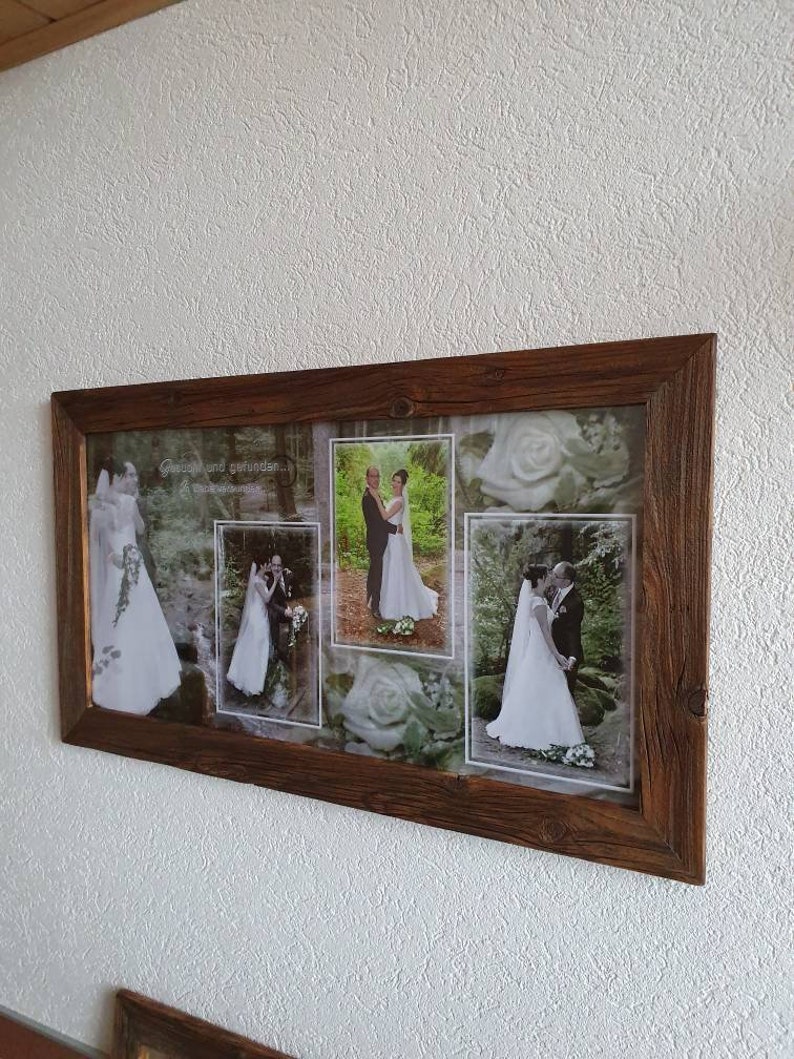 May include: A rustic wooden frame with a collage of wedding photos. The photos show a bride and groom in various poses, including a close-up of the bride's bouquet. The text "Gl&uuml;ck und Gesundheit..." is visible in the top left corner of the frame.