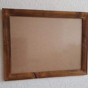May include: A rustic wooden picture frame with a brown finish. The frame is empty and ready to display a photo or artwork.