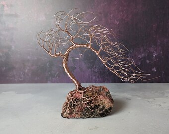 Windswept rose gold coloured copper wire tree on a rhodonite base