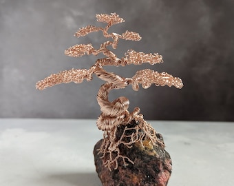 Rose gold coloured copper wire tree on a rhodonite base