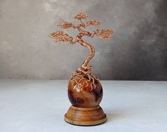 Copper wire tree on a carnelian sphere with a natural wooden sphere holder