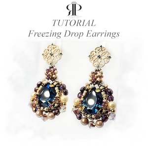 May include: A pair of drop earrings featuring a central dark blue teardrop crystal surrounded by small purple, cream, and metallic beads. The top consists of a gold-toned filigree component. Text reads: TUTORIAL Freezing Drop Earrings.