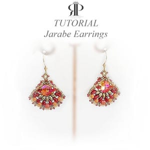 May include: Pair of handmade Jarabe earrings. These earrings feature a fan-shaped design with a central, faceted, orange-pink crystal surrounded by smaller red and gold-toned beads. The earrings are suspended from gold-coloured hooks.