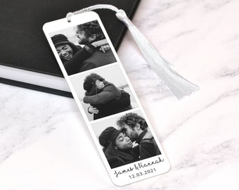 May include: A white bookmark with a black and white photo collage of a couple. The photos show the couple hugging and kissing. The bookmark has a white tassel and the text "James & Hannah 12.03.2021" printed on the bottom.