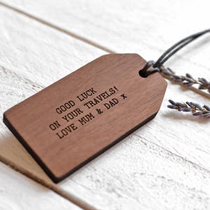 May include: A wooden luggage tag with the text "Good luck on your travels! Love Mum & Dad x" engraved on it.