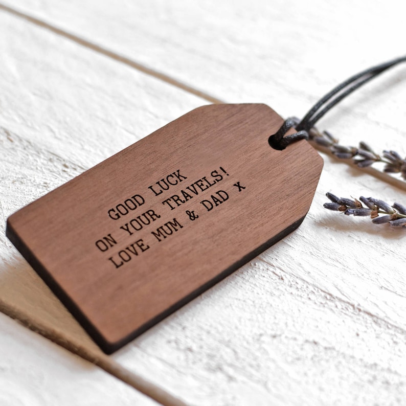 May include: A wooden luggage tag with the text "Good luck on your travels! Love Mum & Dad x" engraved on it.