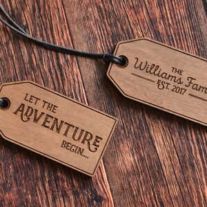 May include: Two wooden tags with black string. One tag says "Let the Adventure Begin..." and the other tag says "The Williams Family Est. 2017".