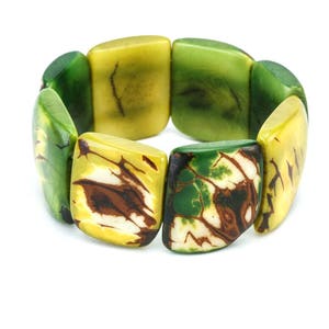 May include: A green, yellow, and brown patterned bracelet made of square-shaped beads.