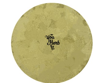 Può includere: Superficie rotonda e strutturata di colore oro, con il testo nero "You Herb It". Il design presenta un aspetto sottile e screziato, che evoca uno stile vintage o artigianale. L'immagine suggerisce un prodotto legato alle erbe o ai prodotti naturali.